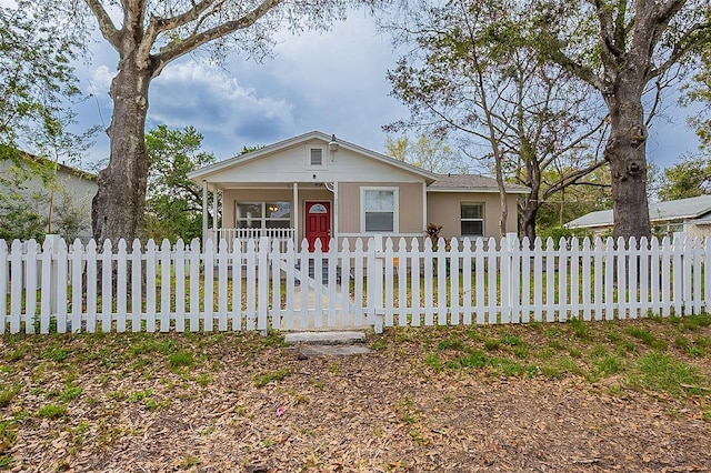 view of front of home featuring covered porch and a fenced front yard