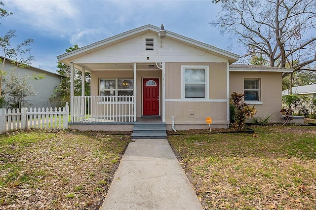 bungalow-style house featuring a porch and fence