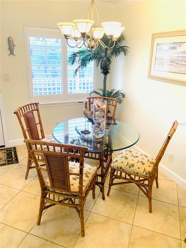 tiled dining space with a chandelier, baseboards, and crown molding