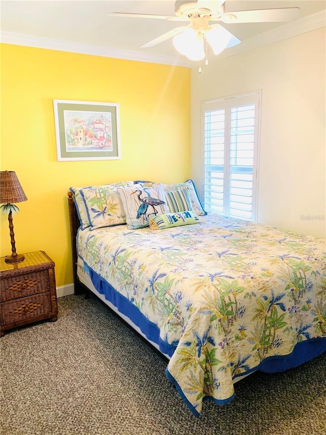 carpeted bedroom featuring crown molding, baseboards, and ceiling fan