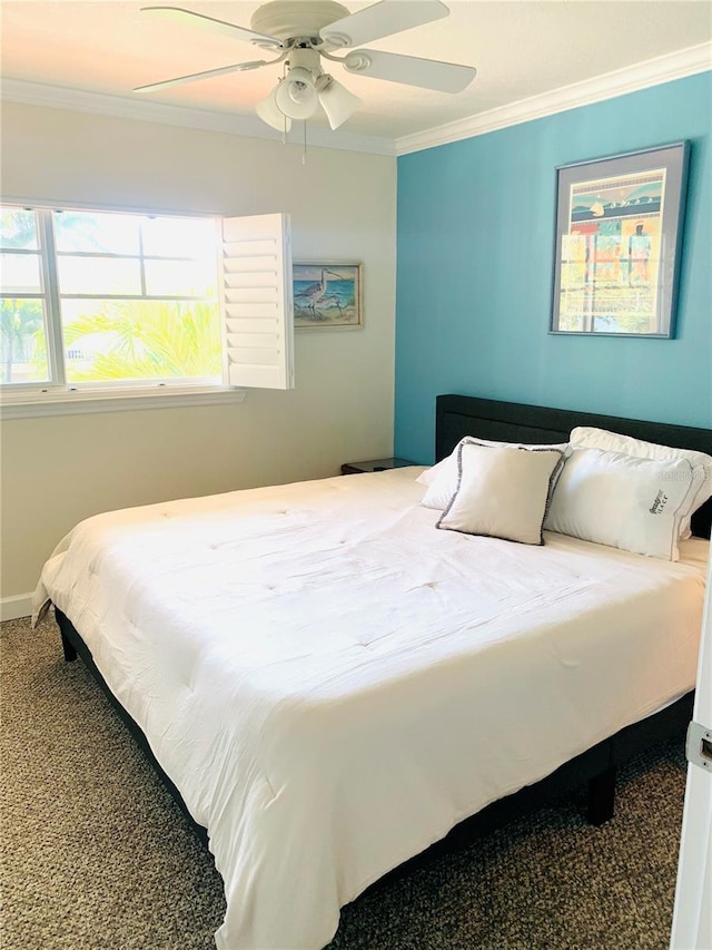 carpeted bedroom featuring ceiling fan, baseboards, and crown molding