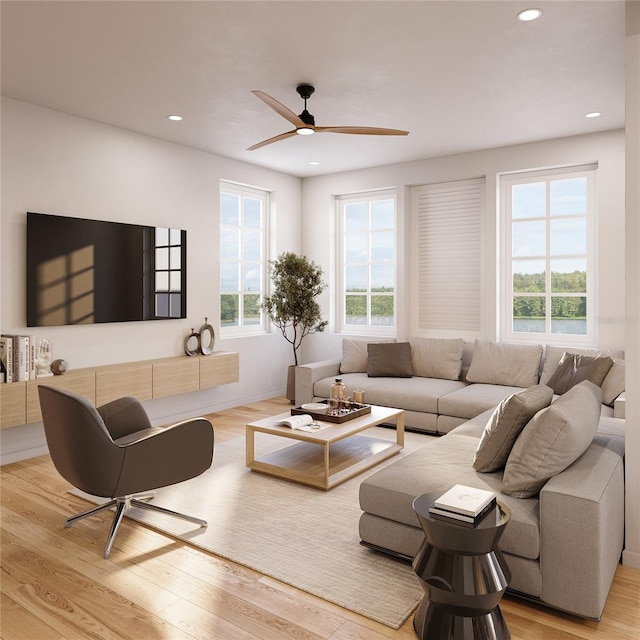 living room featuring a healthy amount of sunlight, light wood finished floors, and recessed lighting