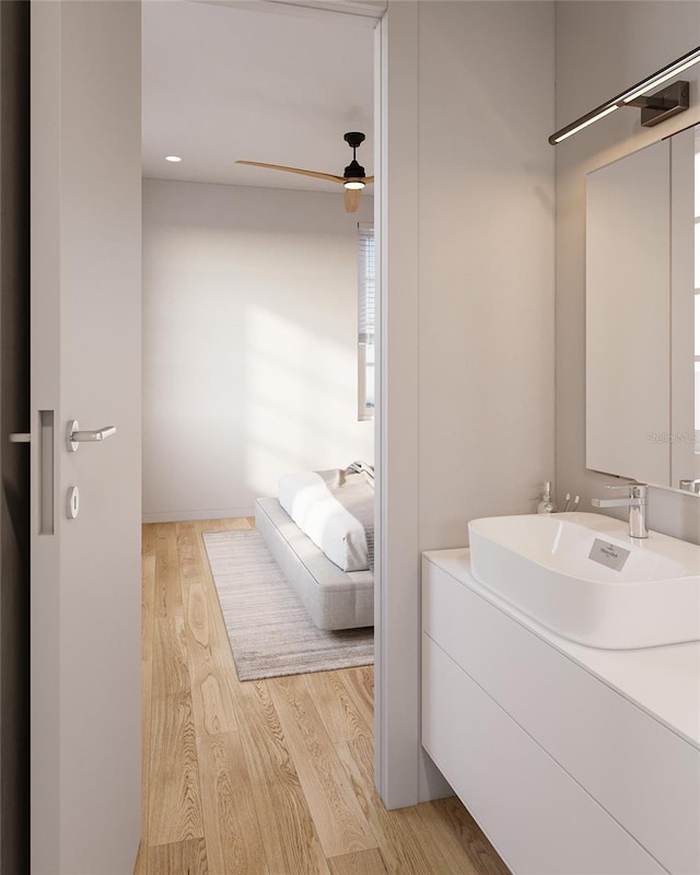 bathroom featuring ceiling fan, wood finished floors, and vanity