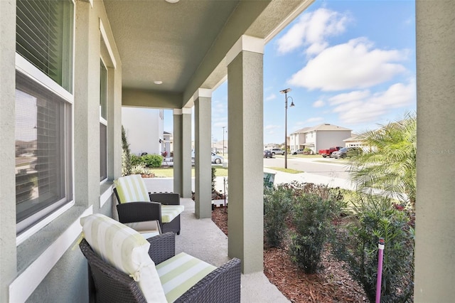 view of patio / terrace with a porch and a residential view