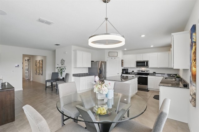 dining room featuring light tile patterned flooring, visible vents, and recessed lighting