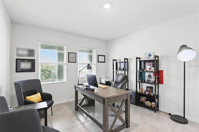 office space with baseboards and light tile patterned floors