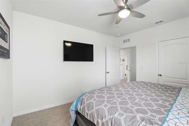 bedroom featuring a textured ceiling, carpet, visible vents, and baseboards