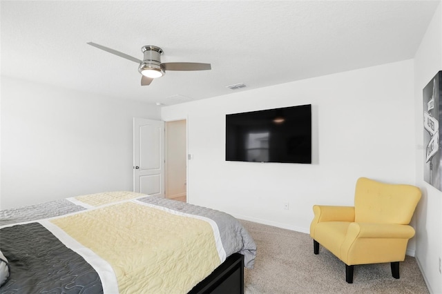 bedroom featuring baseboards, visible vents, a ceiling fan, a textured ceiling, and carpet floors