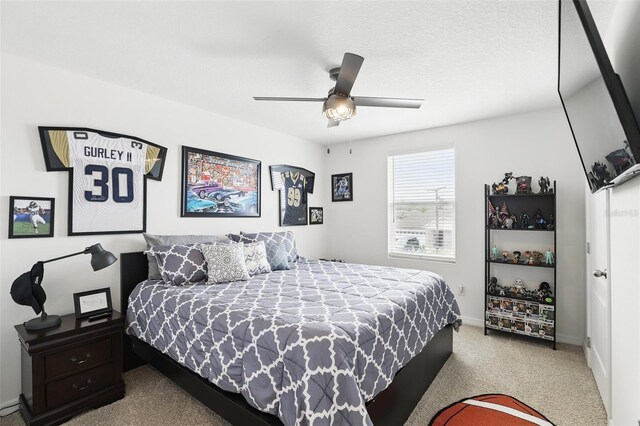 carpeted bedroom featuring a textured ceiling, a ceiling fan, and baseboards