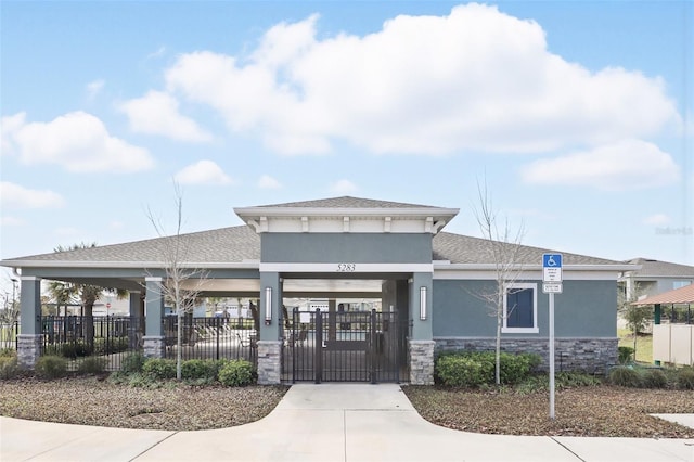 view of building exterior featuring concrete driveway and fence