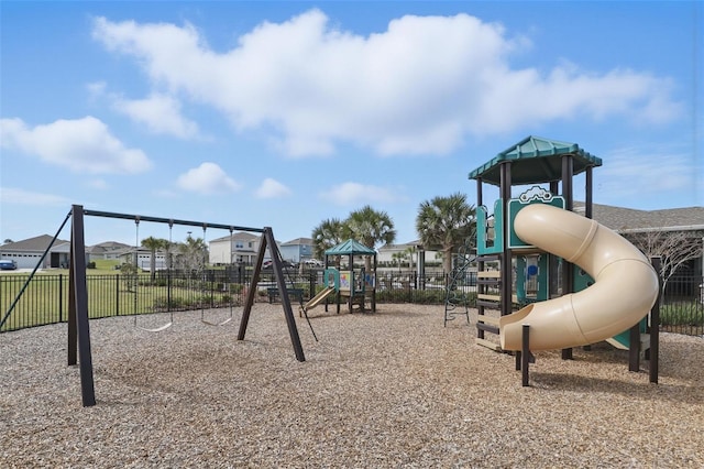 communal playground featuring a residential view and fence