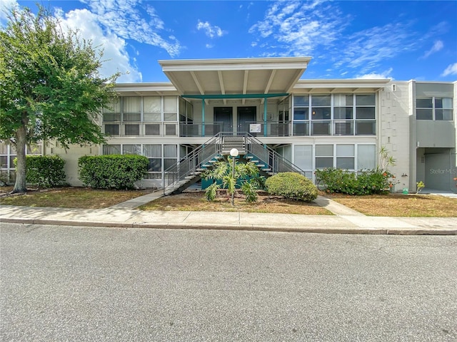 view of property featuring stairs