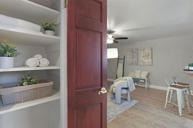 interior space with ceiling fan, baseboards, and built in features