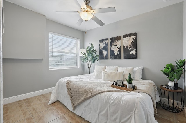 bedroom with light tile patterned floors, baseboards, and a ceiling fan