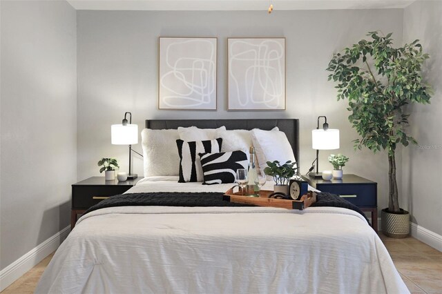 bedroom with baseboards and wood finished floors