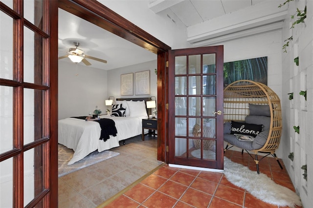 bedroom featuring french doors, beamed ceiling, and tile patterned flooring