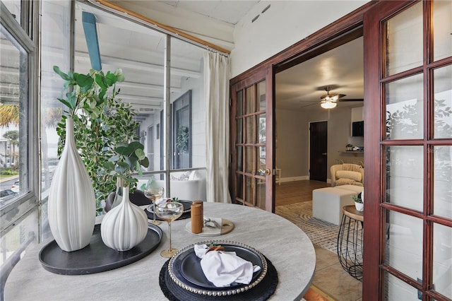 sunroom featuring a ceiling fan