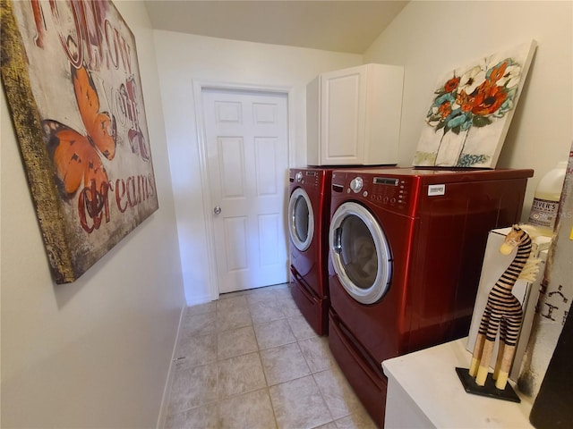 laundry room featuring separate washer and dryer, light tile patterned flooring, cabinet space, and baseboards