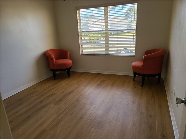 living area featuring baseboards and wood finished floors