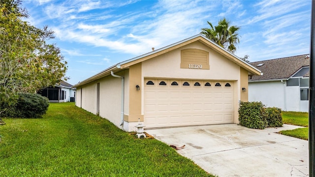 view of front facade featuring an attached garage, driveway, a front lawn, and stucco siding