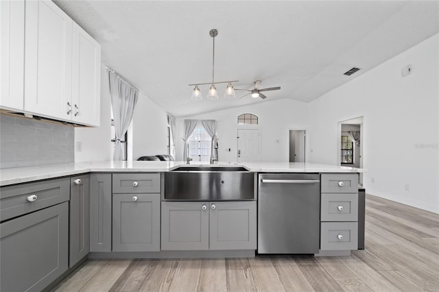 kitchen featuring gray cabinets, visible vents, dishwasher, and a sink