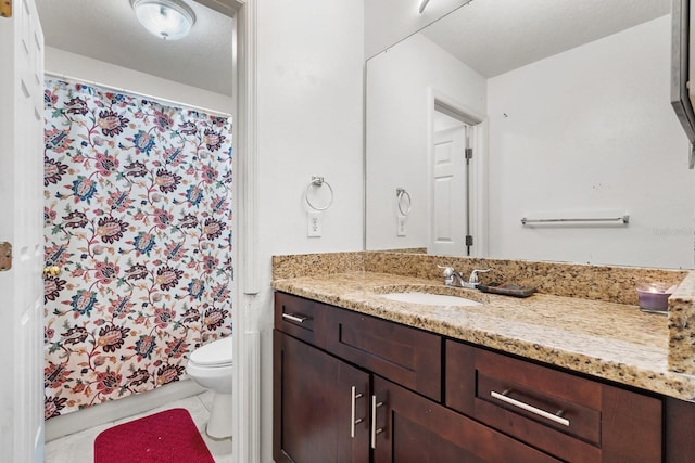 full bath with a shower with shower curtain, toilet, vanity, a textured ceiling, and tile patterned flooring