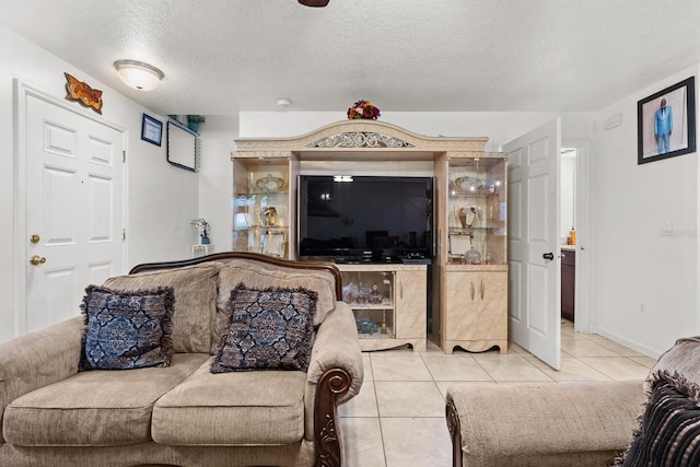 living room featuring light tile patterned floors and a textured ceiling