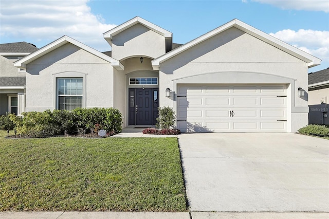 view of front of property featuring a garage, driveway, a front lawn, and stucco siding