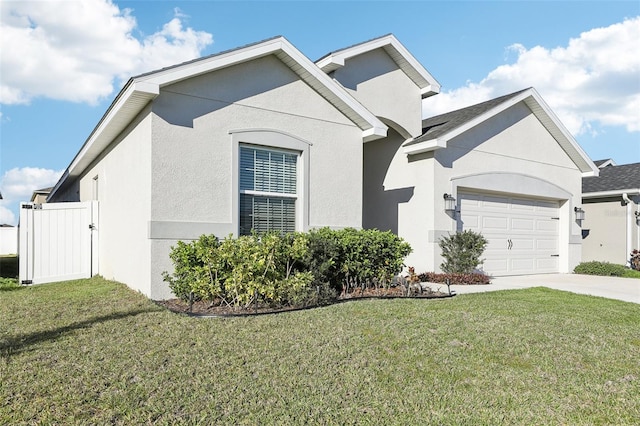 single story home with a garage, a front lawn, and stucco siding