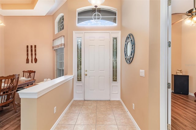 foyer with light tile patterned floors and baseboards