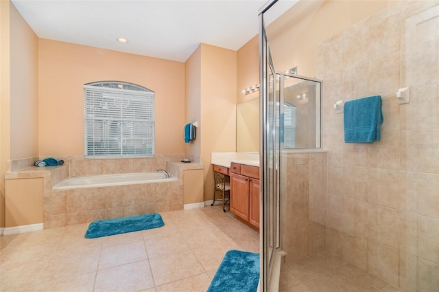 bathroom with a bath, tile patterned floors, vanity, a shower stall, and a wealth of natural light