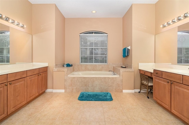 bathroom with a sink, two vanities, tile patterned flooring, and a bath