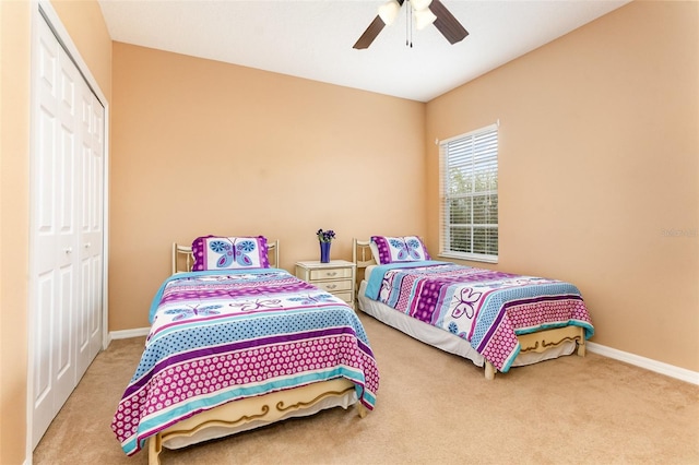 bedroom featuring ceiling fan, baseboards, a closet, and carpet flooring