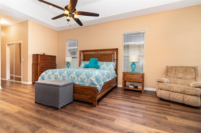 bedroom featuring wood finished floors, a ceiling fan, and baseboards