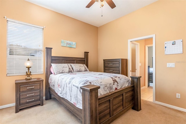 bedroom featuring light colored carpet, ceiling fan, and baseboards