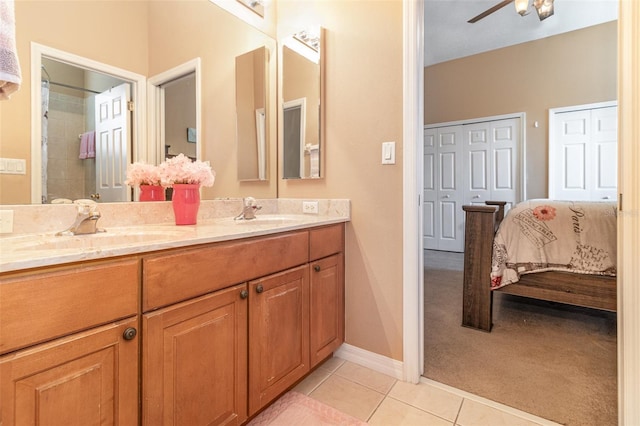 bathroom with tile patterned flooring, a sink, ensuite bath, and ceiling fan