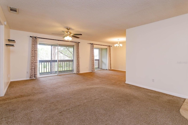 empty room with baseboards, visible vents, a textured ceiling, and carpet flooring