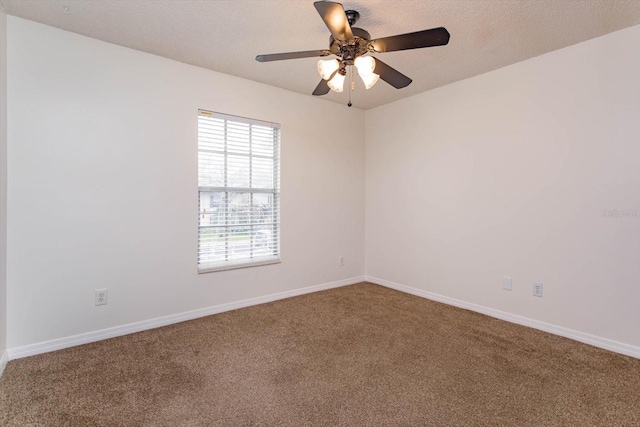 empty room featuring carpet, baseboards, ceiling fan, and a textured ceiling