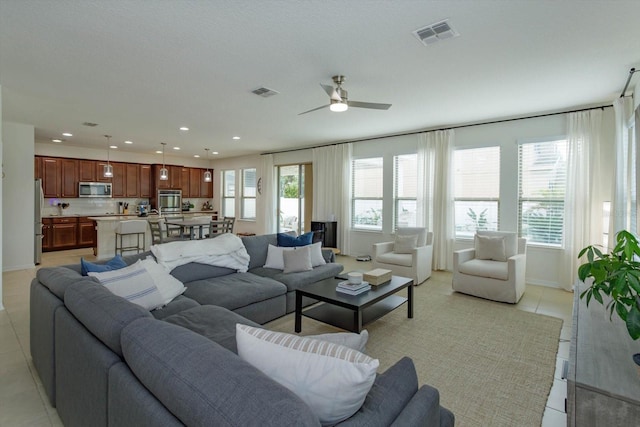 living room with ceiling fan, light tile patterned flooring, visible vents, and recessed lighting