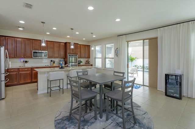 dining space featuring light tile patterned flooring, wine cooler, visible vents, and recessed lighting