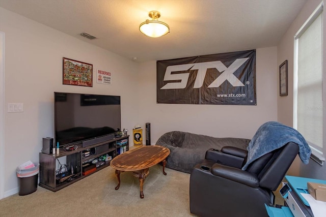 carpeted living area with visible vents and a textured ceiling