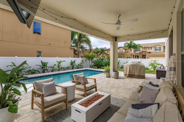 view of patio with an outdoor fire pit, a fenced in pool, ceiling fan, a fenced backyard, and a grill