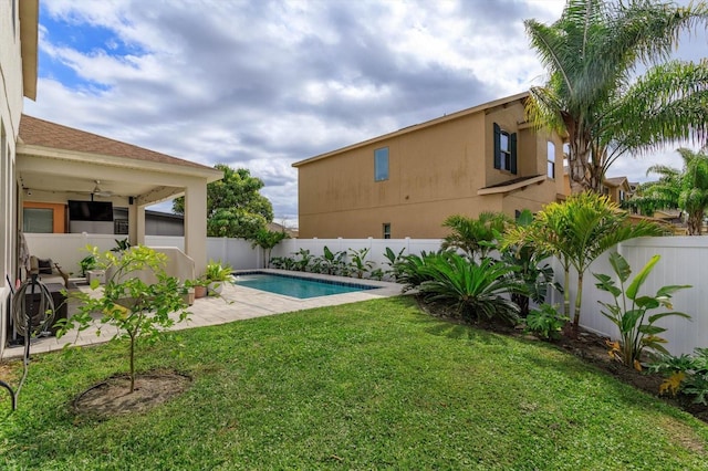 view of yard with a patio, a fenced backyard, a fenced in pool, and a ceiling fan