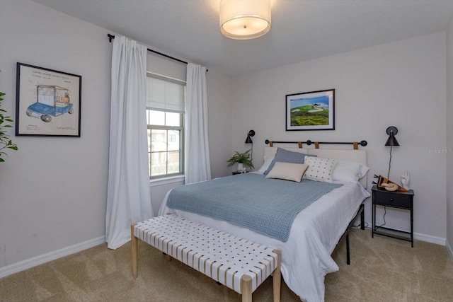 bedroom featuring light carpet and baseboards