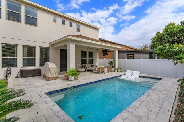 rear view of house with ceiling fan, fence, an outdoor hangout area, and a patio