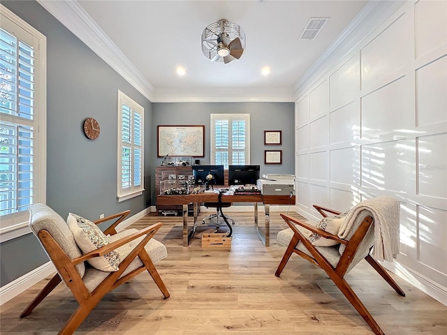 home office with baseboards, light wood-style flooring, visible vents, and crown molding