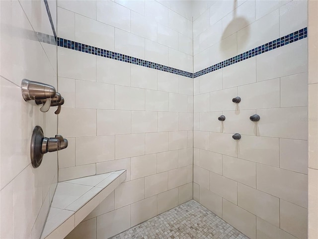 bathroom with a tile shower