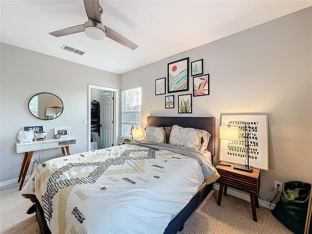 carpeted bedroom with visible vents, ceiling fan, and baseboards