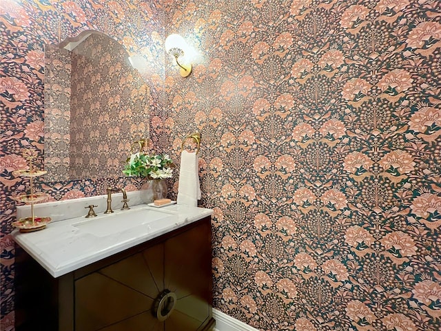 bathroom with vanity and wallpapered walls