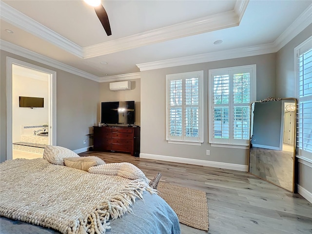 bedroom featuring a raised ceiling, a wall unit AC, wood finished floors, and crown molding